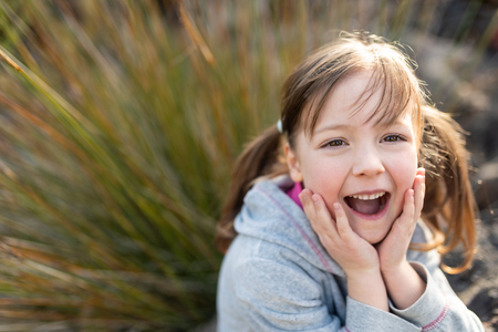 Portrait of an amazed adorable little girlの写真素材