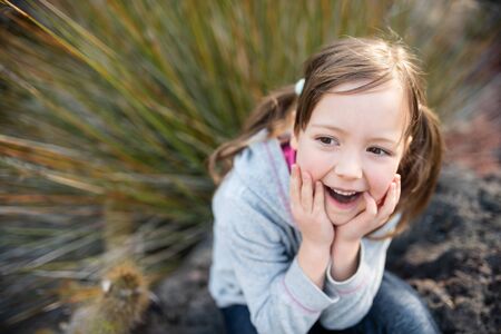 Surprised child looking away outdoors