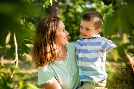 Caring mother looking at her son with loveの写真素材