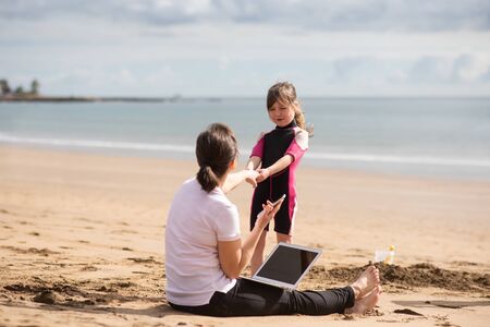 Busy mother not taking part in activities of kidの写真素材