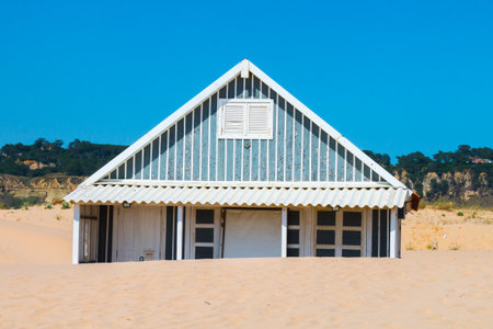 Costa de Caparica is the famous tourist destination, with the typical tiny colorful house, big sandy beaches and the ocean waves in the south of Portugal, near Lisbon.のeditorial素材