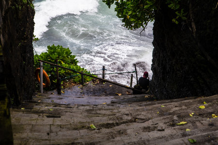 People enjoy their free time around the Tanah Lot water temple in Bali, one of the most popular temple in Indonesia. The temples are full of tourists all year. The Balinese temples are arranged according to the physical and spiritual realm of Balinese peoのeditorial素材