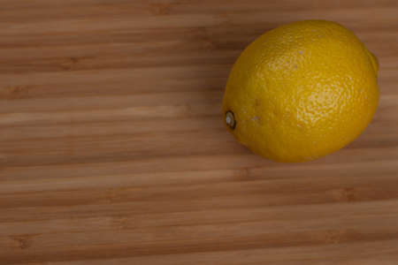 Fresh yellow lemons on a wood brown backgroundの写真素材