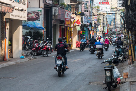 Ho Chi Minh City, Vietnam: 02/06/2020 : colorful perspective of one of the main Street with numerous hotel, bar and shop sign boards, crowded with people & motorbikesのeditorial素材