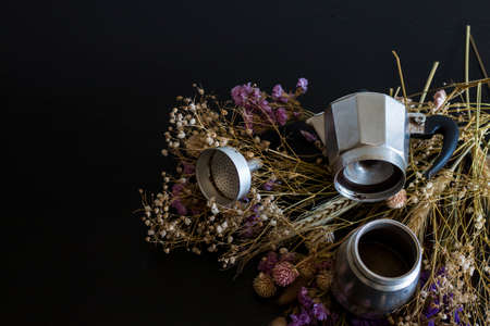 Coffee making concept. Ingredients for making moka coffee. Moka pot with coffee on dark background...