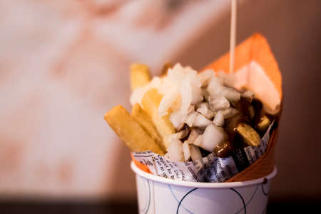 Close-up of tomato Spicy sauce and Fresh French fries, deep fried Homemade Baked potato chips with close-up of spicy sauce and crunchy onions on the wooden background.の写真素材