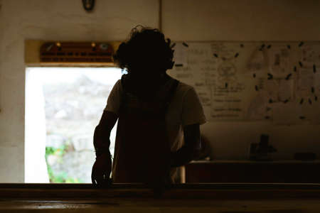 A young man working as carpenter in his wood workshop. Wood worker designing and handcrafting new...
