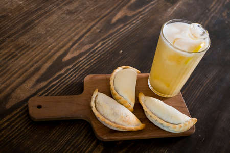 Traditional baked Argentine empanadas savory pastries with meat beef stuffing and vegetables against...