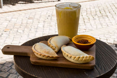 Traditional baked Argentine empanadas savory pastries with meat beef stuffing and vegetables against...