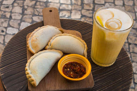 Traditional baked Argentine empanadas savory pastries with meat beef stuffing and vegetables against...
