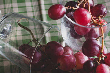 Red grapes, large bunch of fruits, fresh and tasty simple food with brights red and violet colors on...