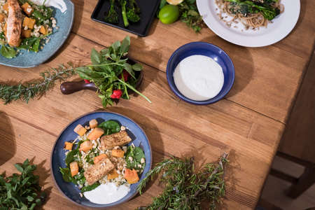 Grilled vegetables and healthy food dishes on a fancy wooden table. Mediterranean food dishes with...