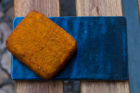 Different type pf simple american fried food on an wooden background. Chicken dishes. meatballs,chicken breast, mozzarella, wings. Different food. A variety of meat dishes in a minimal composition.の写真素材