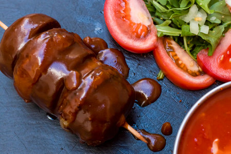 a mix of american fast food, junkie food. A fried meat like hamburger or beef steak with different...