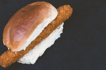 fried mozzarella cheese and fried hot-dog with soft white bread and crispy french fries with sauces. Southern Country Fried Chicken Sandwich with Mayo and fried potatoes.の写真素材