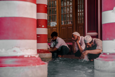 COLOMBO, SRI LANKA - 03-04-2019 : The decorative red-and-white facade of Jamiul Alfar Mosque, Red Mosque, in the oldest districts in Colombo, people stay around praying and spending their daily life.のeditorial素材