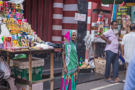 COLOMBO, SRI LANKA - 03-04-2019 : The decorative red-and-white facade of Jamiul Alfar Mosque, Red Mosque, in the oldest districts in Colombo, people stay around praying and spending their daily life.のeditorial素材