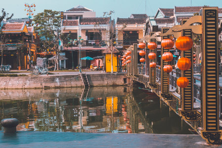 Hoi An, Vietnam - 09-04-2018: Colorful view of busy street and crowded river in Hoi An, Vietnam,...