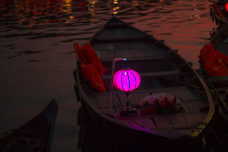 Hoi An, Vietnam - 09-04-2018: Colorful view of busy street and crowded river in Hoi An, Vietnam, famous for mixed cultures and architecture. Traditional colorful lanterns spread light all around.のeditorial素材