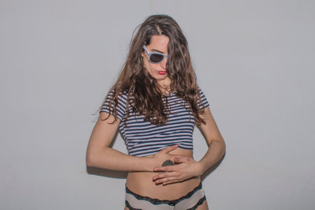 High fashion look glamor stylish beautiful young brunette woman model with red lips in summer bright colorful hipster summer cloth. Funny crazy glamor stylish sexy smiling girl in natural posing.の写真素材