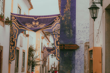 OBIDOS, PORTUGAL - 08-09-2020 : Souvenir shops and colorful narrow streets of the medieval portuguese city of Ãbidos, a tourist attraction in central Portugal. famous destination for its architecture.のeditorial素材