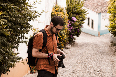 OBIDOS, PORTUGAL - 08-09-2020 : Souvenir shops and colorful narrow streets of the medieval portuguese city of Ãbidos, a tourist attraction in central Portugal. famous destination for its architecture.のeditorial素材