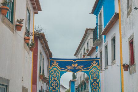 OBIDOS, PORTUGAL - 08-09-2020 : Souvenir shops and colorful narrow streets of the medieval...