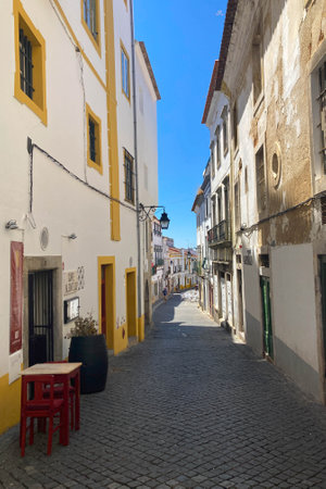 Evora, Portugal: 09/05/2021: Street view with beautiful old residential buildings in Evora city in Portugal with people around making their daily lifeのeditorial素材