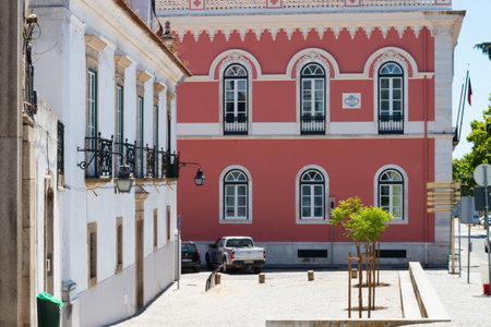 Evora, Portugal: 09/05/2021: Street view with beautiful old residential buildings in Evora city in Portugal with people around making their daily lifeのeditorial素材