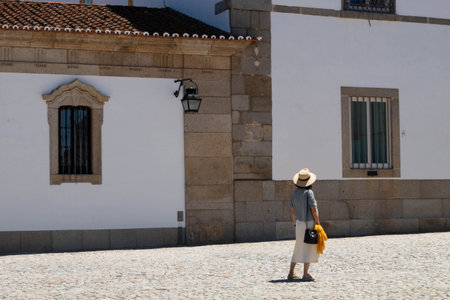 Evora, Portugal: 09/05/2021: Street view with beautiful old residential buildings in Evora city in Portugal with people around making their daily lifeのeditorial素材