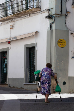 Evora, Portugal: 09/05/2021: Street view with beautiful old residential buildings in Evora city in Portugal with people around making their daily lifeのeditorial素材