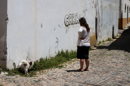 Evora, Portugal: 09/05/2021: Street view with beautiful old residential buildings in Evora city in Portugal with people around making their daily lifeのeditorial素材