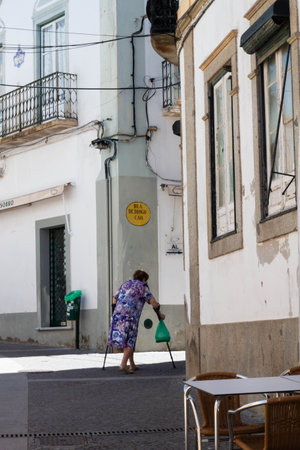 Evora, Portugal: 09/05/2021: Street view with beautiful old residential buildings in Evora city in Portugal with people around making their daily lifeのeditorial素材
