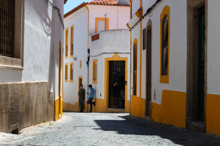 Evora, Portugal: 09/05/2021: Street view with beautiful old residential buildings in Evora city in...
