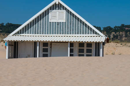 characteristic wooden house along the beach side at Costa da Caparica in Lisbon, Portugal.の写真素材