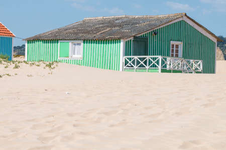 characteristic wooden house along the beach side at Costa da Caparica in Lisbon, Portugal.の写真素材