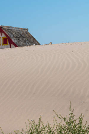 characteristic wooden house along the beach side at Costa da Caparica in Lisbon, Portugal.の写真素材
