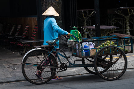 Ho Chi Minh city, Vietnam - 7 Feb 2021: people walking in teh city center of Ho chi Minh, Vietnam, people in the crowd streets with motorbyke, shops and parksのeditorial素材