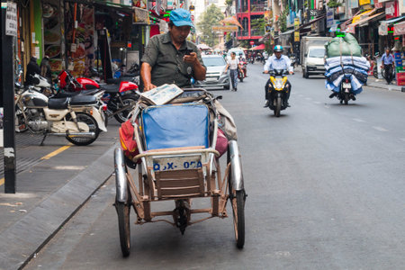 Ho Chi Minh city, Vietnam - 7 Feb 2021: people walking in teh city center of Ho chi Minh, Vietnam, people in the crowd streets with motorbyke, shops and parksのeditorial素材