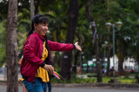 Ho Chi Minh city, Vietnam - 7 Feb 2021: people walking in teh city center of Ho chi Minh, Vietnam, people in the crowd streets with motorbyke, shops and parksのeditorial素材