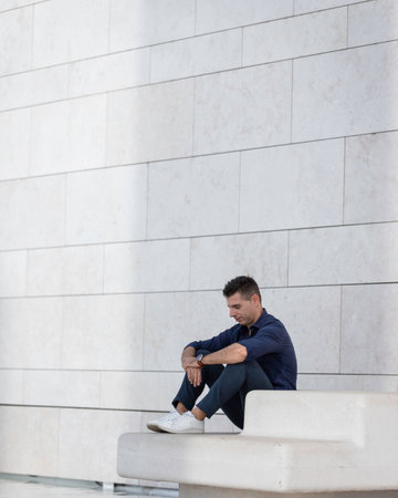 Portrait of a beautiful young man posing for a photo session along the tejo riverside in Lisbon,...
