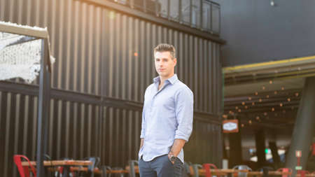 Success concept. Stylish young business man working as freelance architect in Lisbon is standing...
