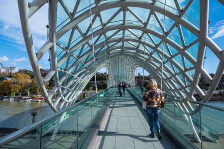 Tbilisi, GEORGIA : 05 - 10 - 2022 : The Bridge of Peace is a modern bow-shaped pedestrian bridge over the Kura River in old Tbilisi, Georgiaのeditorial素材