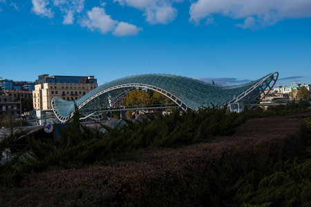 Tbilisi, GEORGIA : 05 - 10 - 2022 : The Bridge of Peace is a modern bow-shaped pedestrian bridge over the Kura River in old Tbilisi, Georgiaのeditorial素材