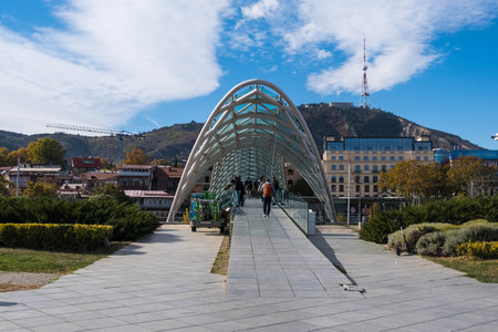 Tbilisi, GEORGIA : 05 - 10 - 2022 : The Bridge of Peace is a modern bow-shaped pedestrian bridge over the Kura River in old Tbilisi, Georgiaのeditorial素材