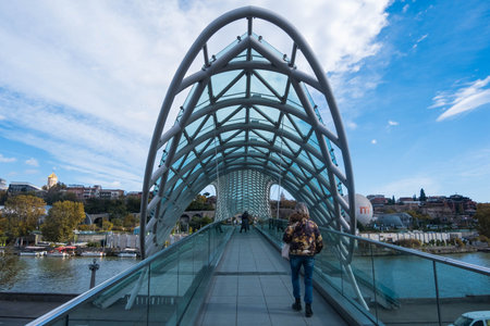 Tbilisi, GEORGIA : 05 - 10 - 2022 : The Bridge of Peace is a modern bow-shaped pedestrian bridge over the Kura River in old Tbilisi, Georgiaのeditorial素材