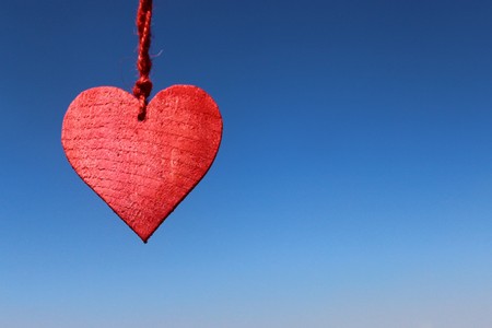 Red heart in front of blue skyの写真素材