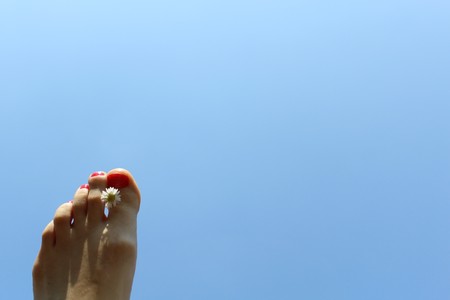 Foot in front of blue sky