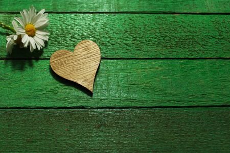 a flower and a heart on green boardsの写真素材