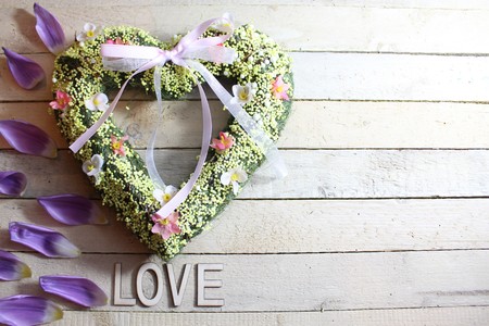 Heart on white wooden background